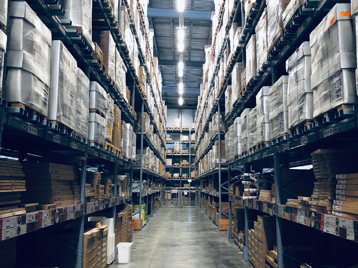 Aisle of a logistics warehouse with fully stocked shelving